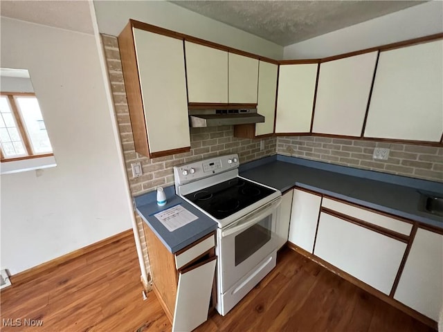 kitchen with light hardwood / wood-style flooring, electric stove, and white cabinets