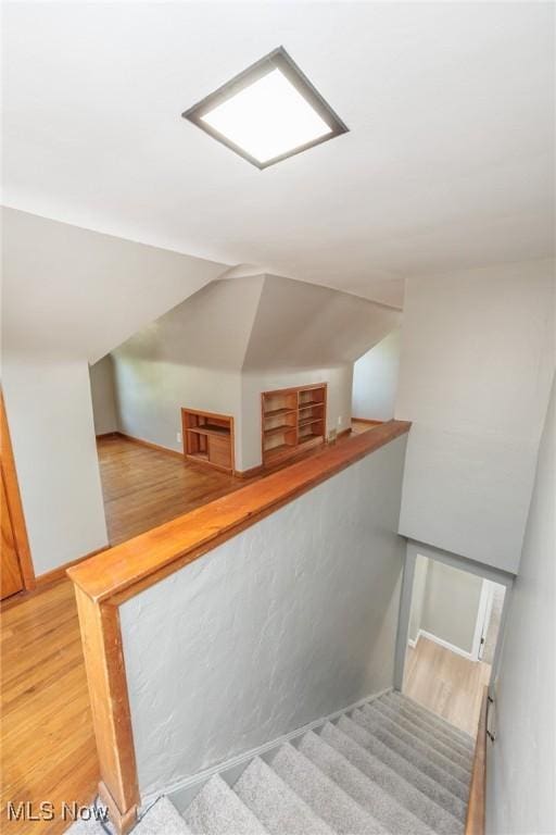stairway with wood finished floors