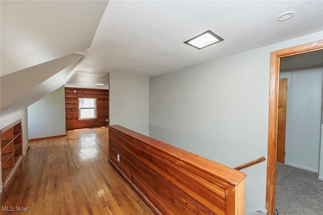 additional living space featuring hardwood / wood-style floors and baseboards