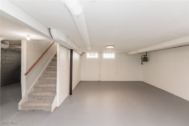 basement featuring stairs and gas meter