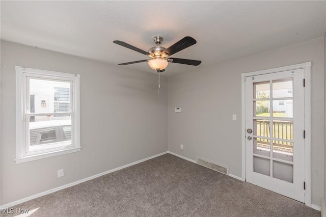 unfurnished room featuring carpet flooring, ceiling fan, and baseboards