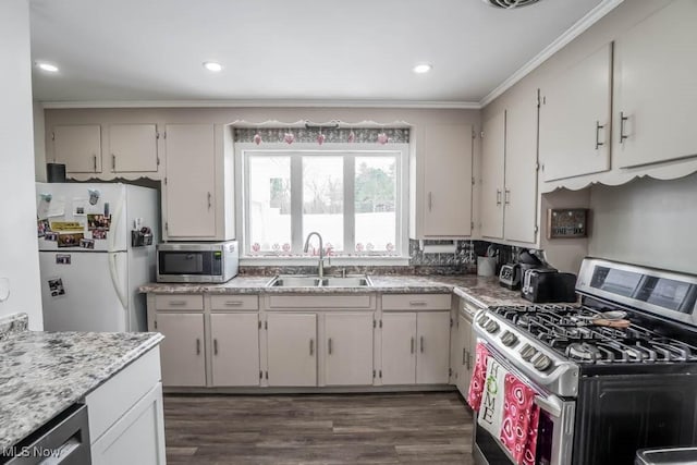 kitchen with sink, appliances with stainless steel finishes, white cabinets, and dark hardwood / wood-style flooring