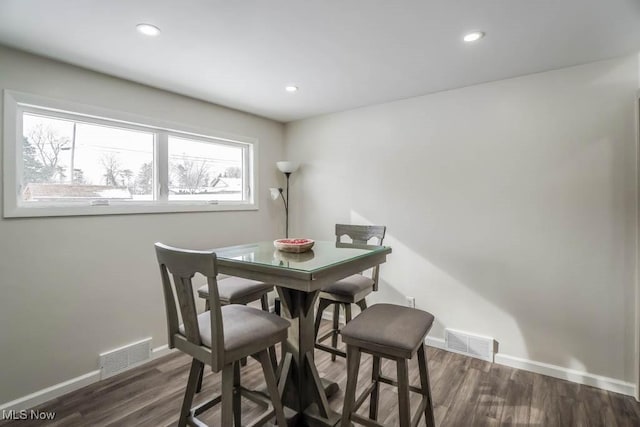 dining area with dark hardwood / wood-style floors