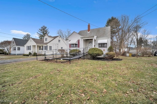 view of front of home featuring a chimney and a front yard