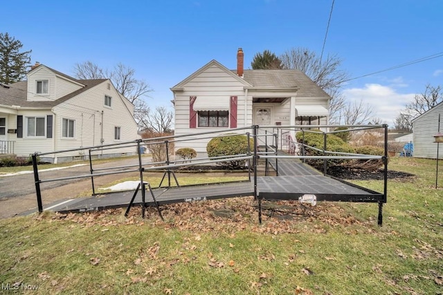 view of front of home featuring fence and a chimney