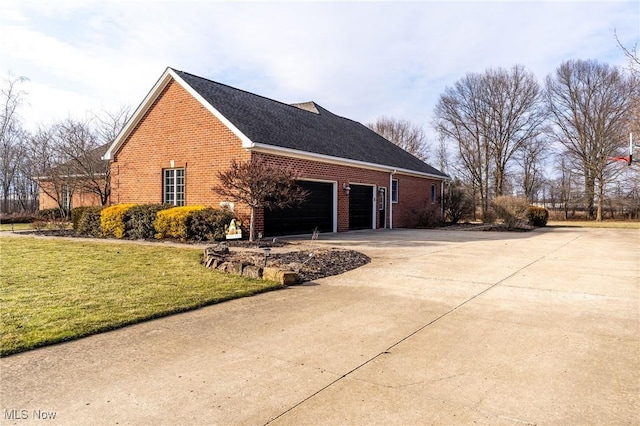 view of property exterior featuring a garage, a yard, brick siding, and driveway