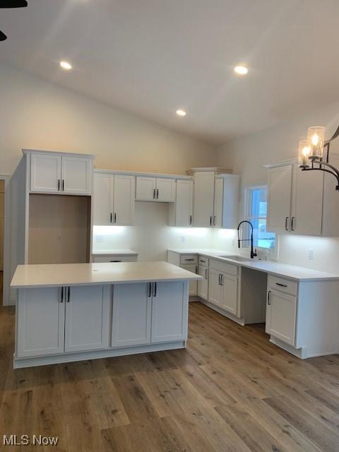 1775 Green Rd, Madison, OH 44057 - kitchen with a sink, a center island, white cabinetry, lofted ceiling, and recessed lighting