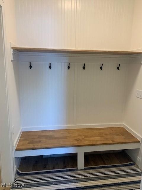 mudroom with baseboards and wood finished floors