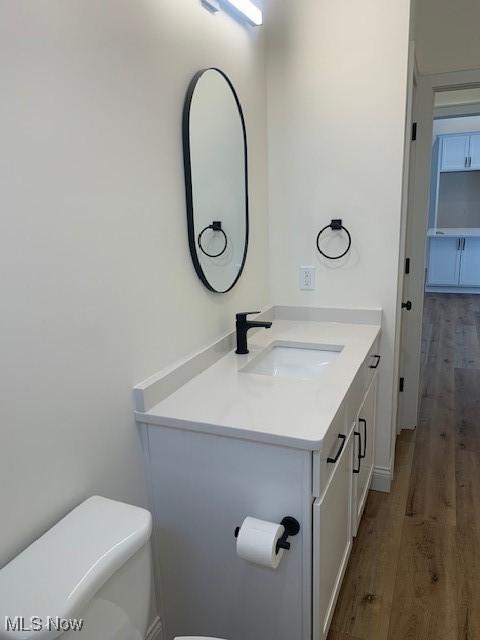 1775 Green Rd, Madison, OH 44057 - bathroom featuring toilet, vanity, and wood finished floors