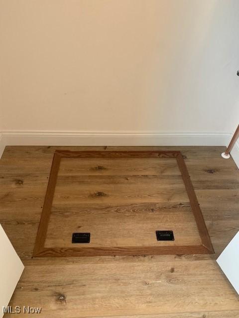 laundry room featuring baseboards and light wood-style floors