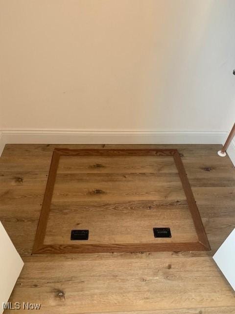 1775 Green Rd, Madison, OH 44057 - detailed view of baseboards and wood finished floors