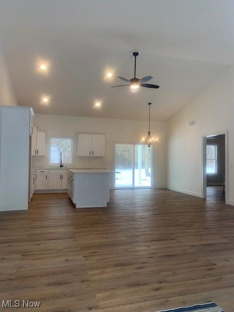 1775 Green Rd, Madison, OH 44057 - kitchen with a ceiling fan, open floor plan, white cabinets, dark wood-style flooring, and high vaulted ceiling