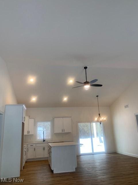 1775 Green Rd, Madison, OH 44057 - kitchen with lofted ceiling, a ceiling fan, wood finished floors, white cabinets, and light countertops