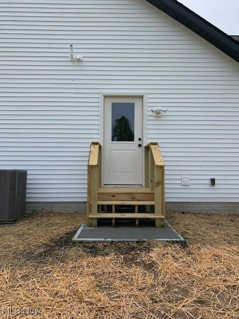 1775 Green Rd, Madison, OH 44057 - view of exterior entry with central air condition unit