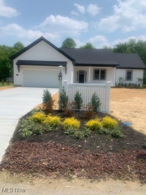 1775 Green Rd, Madison, OH 44057 - ranch-style home with driveway, a garage, and a porch