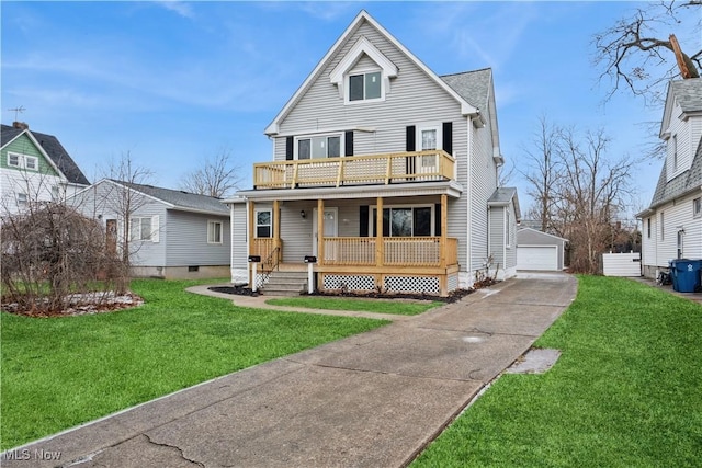 view of front of home featuring a front lawn, a garage, a balcony, and an outdoor structure