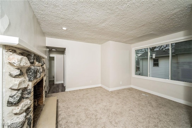 unfurnished living room with carpet and a textured ceiling