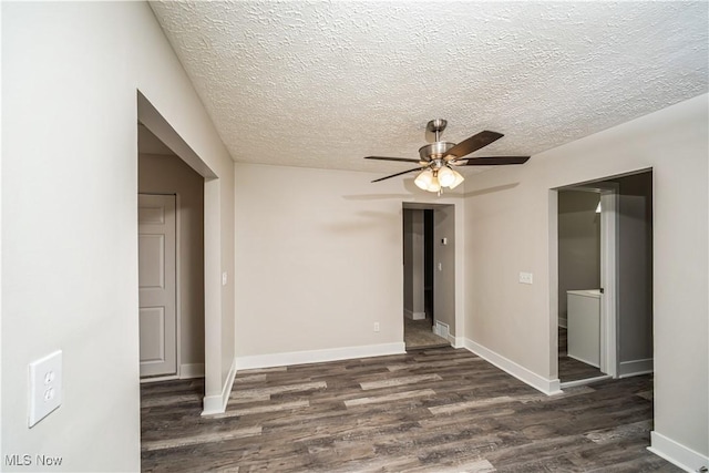 spare room featuring ceiling fan, dark wood-type flooring, and a textured ceiling