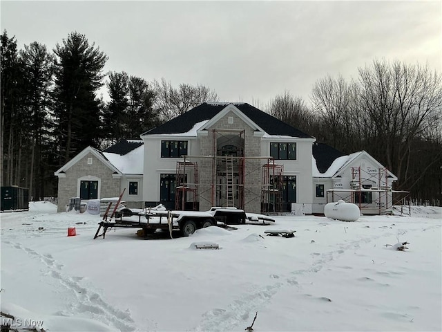 snow covered house with central AC unit