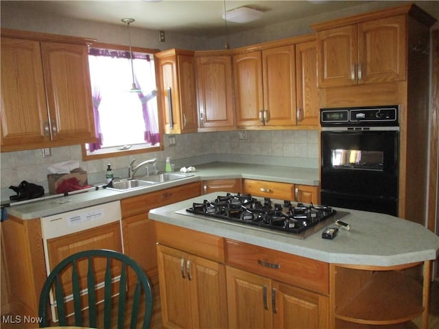 4520 E Wallings Rd, Broadview Heights, OH 44147 - kitchen featuring stainless steel gas cooktop, light countertops, a sink, hanging light fixtures, and backsplash
