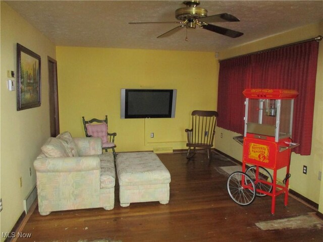 4520 E Wallings Rd, Broadview Heights, OH 44147 - living room featuring wood finished floors, a ceiling fan, baseboards, and a textured ceiling