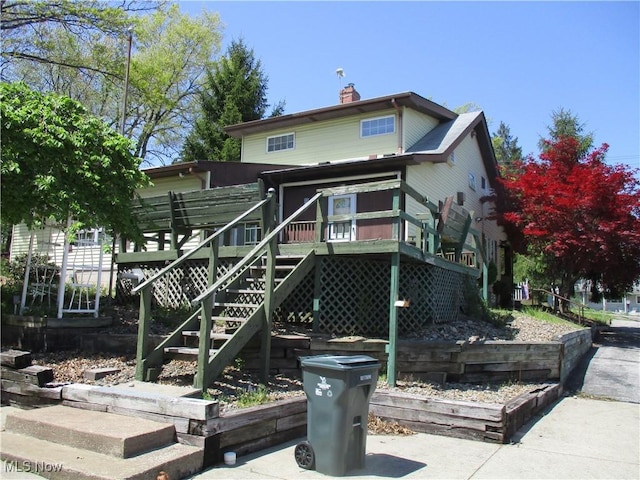 4520 E Wallings Rd, Broadview Heights, OH 44147 - back of property with a chimney, a wooden deck, and stairway