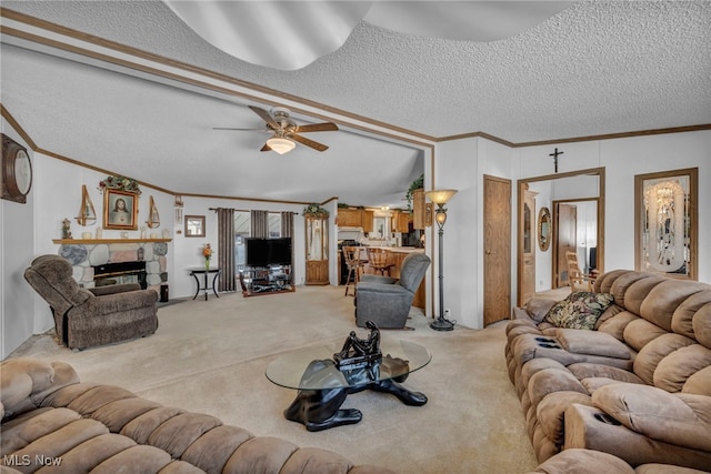 carpeted living room with a textured ceiling, a stone fireplace, and ornamental molding