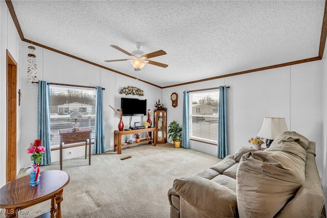 living room featuring lofted ceiling, light colored carpet, ornamental molding, ceiling fan, and a textured ceiling