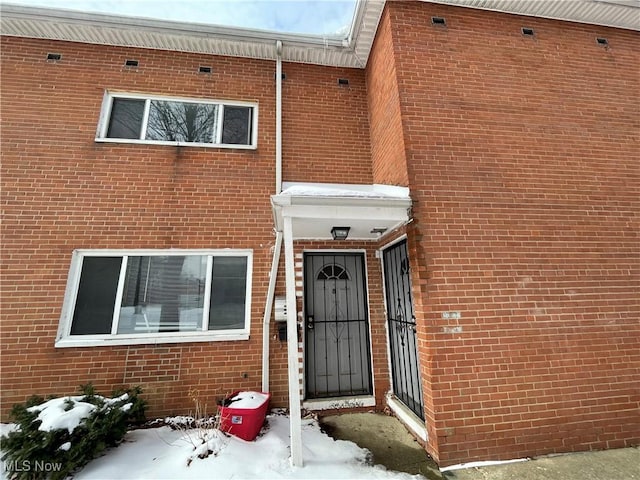 view of snow covered property entrance