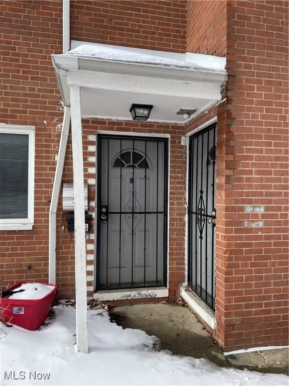 view of snow covered property entrance