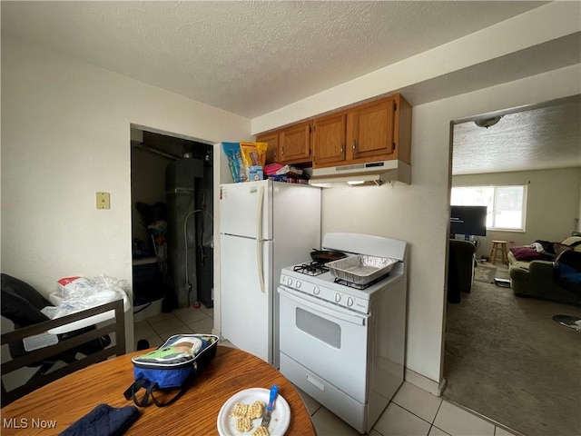 kitchen featuring a textured ceiling, light carpet, and white appliances