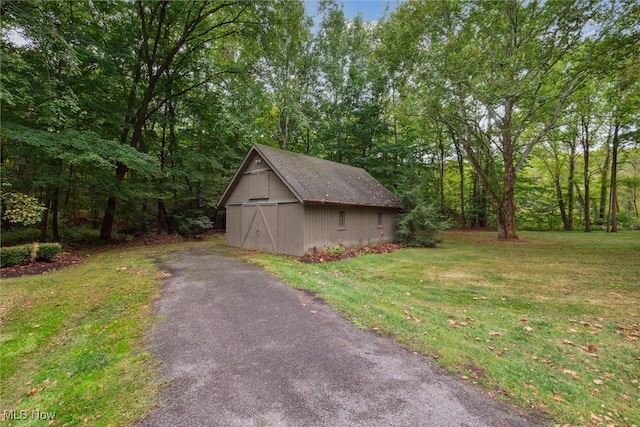 view of outbuilding featuring a lawn