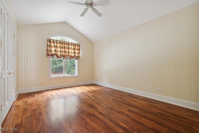 spare room featuring hardwood / wood-style flooring, lofted ceiling, and ceiling fan