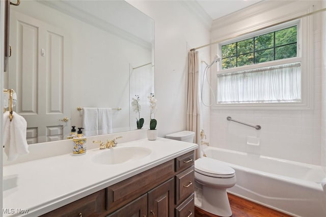 full bathroom with hardwood / wood-style floors, vanity, shower / tub combo, toilet, and ornamental molding