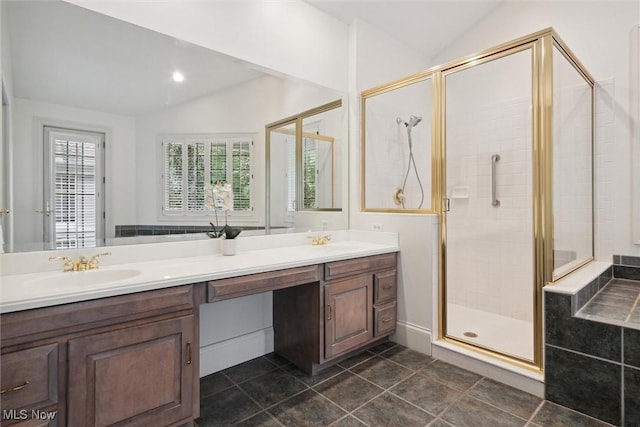 bathroom with vanity, vaulted ceiling, tile patterned flooring, and a shower with shower door