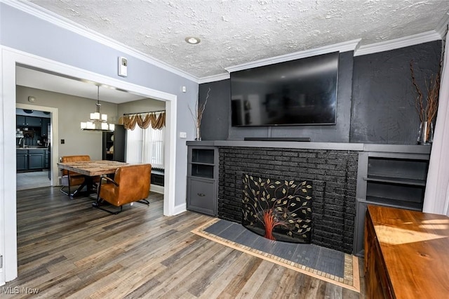 living room with a fireplace, hardwood / wood-style flooring, crown molding, and a textured ceiling