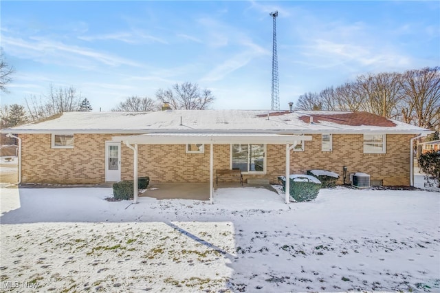 view of snow covered rear of property