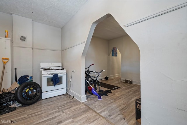 kitchen featuring light hardwood / wood-style flooring and white range with gas cooktop