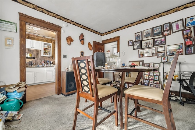 dining room featuring light carpet