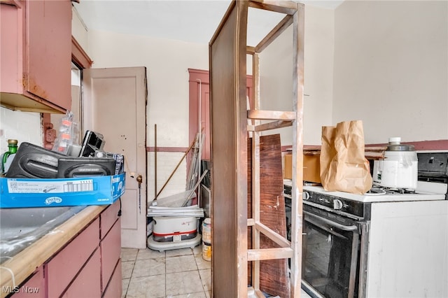 kitchen with light countertops and white range with gas cooktop