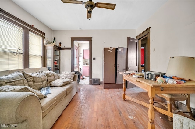 living area featuring a ceiling fan and wood finished floors