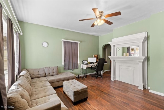 living room with ceiling fan and dark hardwood / wood-style floors