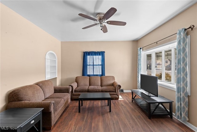 living room with ceiling fan and dark hardwood / wood-style flooring