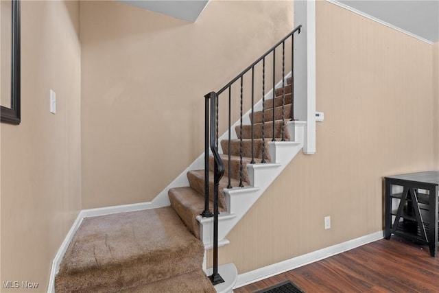 stairs featuring hardwood / wood-style flooring