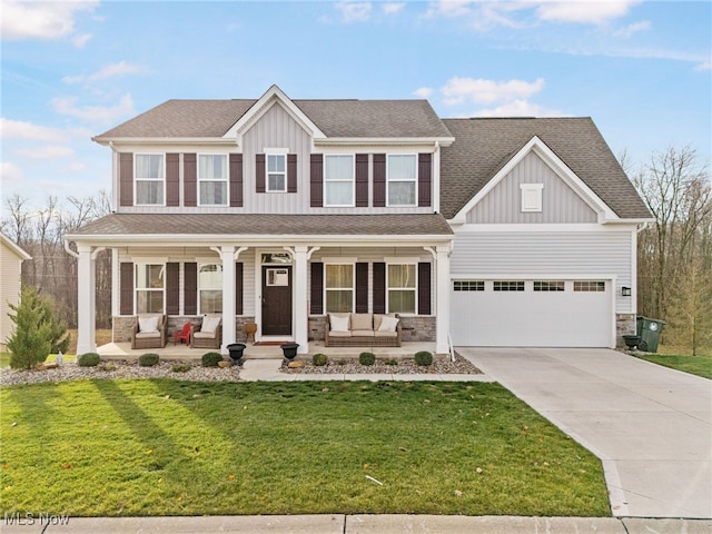 craftsman inspired home with a porch, a front yard, driveway, and board and batten siding