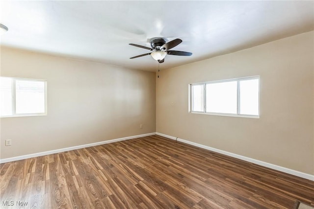 unfurnished room featuring ceiling fan and dark wood-type flooring