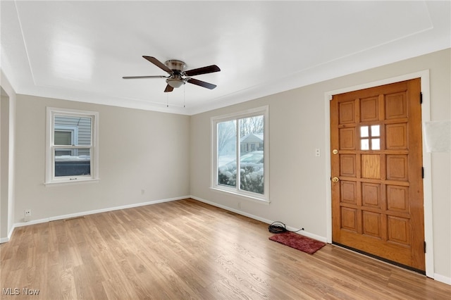 foyer entrance with ceiling fan and light hardwood / wood-style flooring