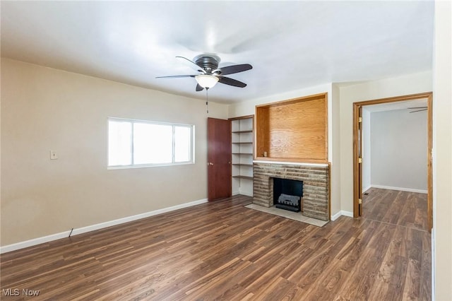 unfurnished living room with ceiling fan, dark hardwood / wood-style floors, and a fireplace