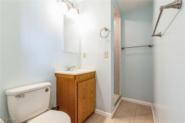 bathroom featuring tile patterned floors, toilet, vanity, and a shower