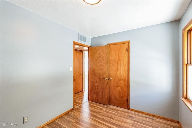 unfurnished bedroom with light wood-type flooring